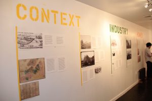 Displaced Urban Histories exhibit wall with "Context" and "Industry" related pieces