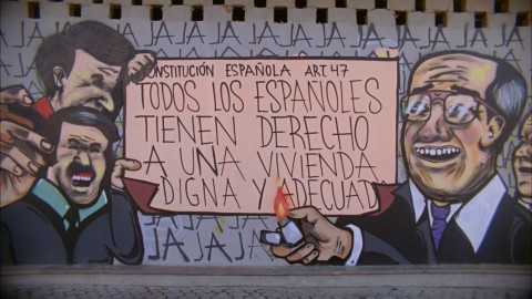 Mural of man holding a lighter to a part of Spain's constitution