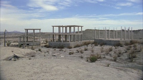 Desert with three building framed but not completed