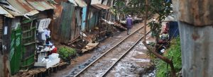 Person walks along tracks in Kibera, Kenya, the largest urban slum in Africa