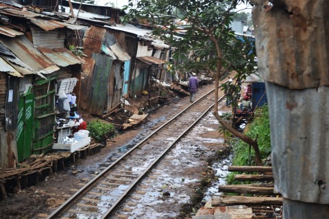 Person walks along tracks in Kibera, Kenya, the largest urban slum in Africa
