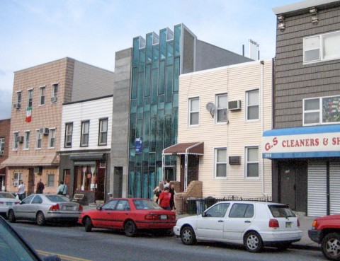 Street view of new glass building with older, low-rise buildings in Williamsburg, Brooklyn