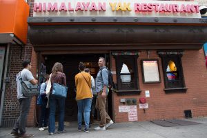 A group of people stand in front of Himalayan Yak Restaurant