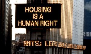 Digital billboard displaying the words "Housing in a Human Right"