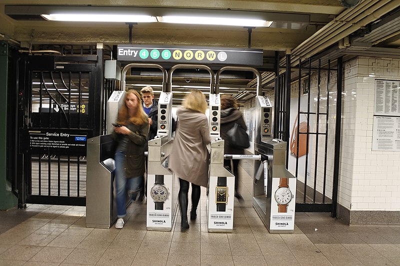 People rushing through the subway turnstiles at Union Square